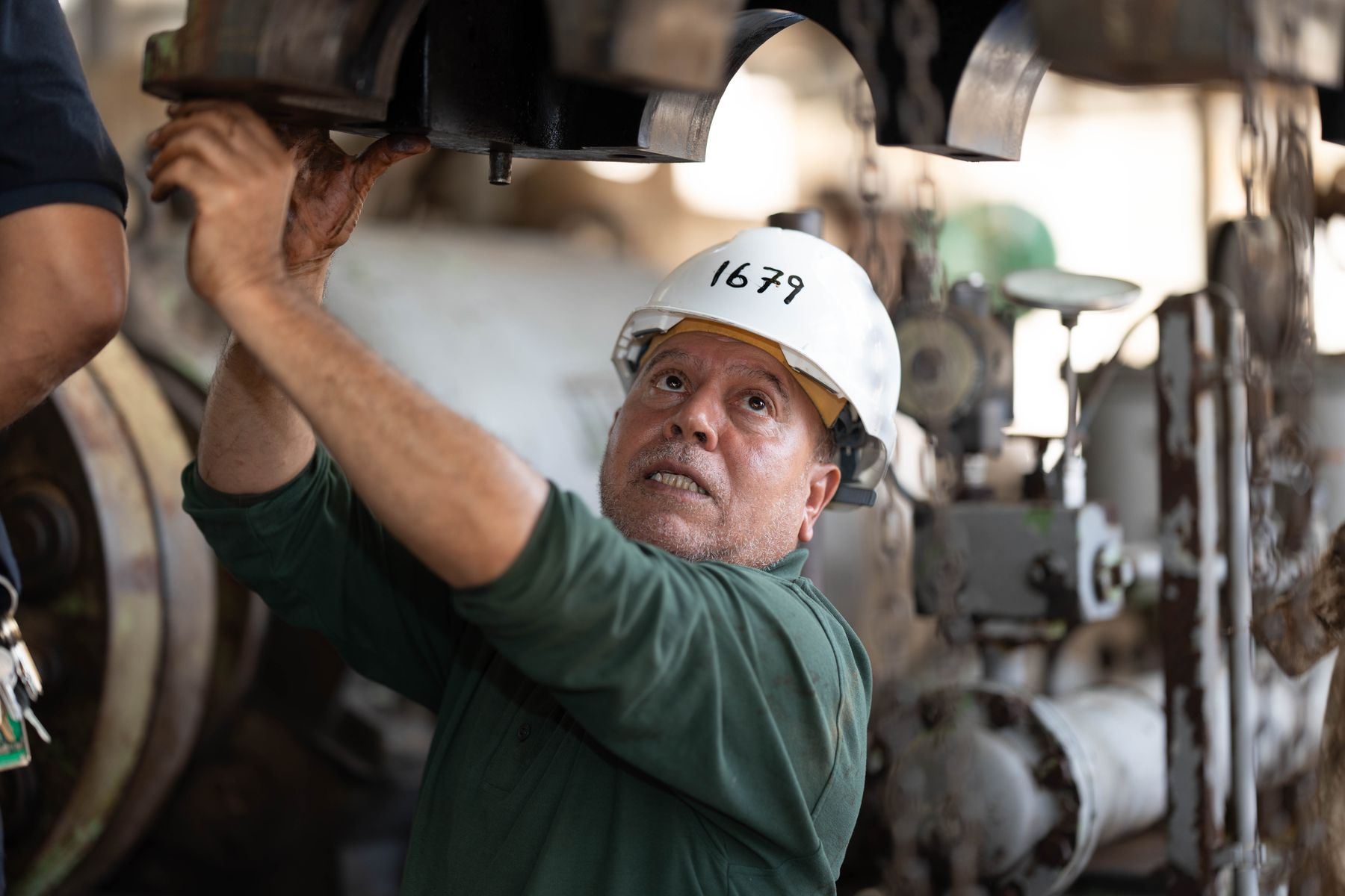 Industrial technician inspecting machinery on a factory floor